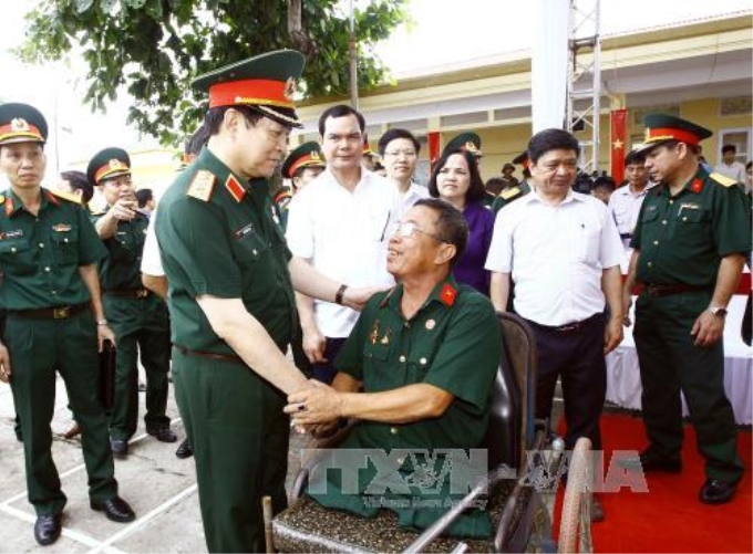 Đại tướng Ngô Xuân Lịch thăm hỏi thương bệnh binh tại Trung tâm nuôi dưỡng thương bệnh binh nặng và điều dưỡng người có công tỉnh Hà Nam. Ảnh: An Đăng/TTXVN